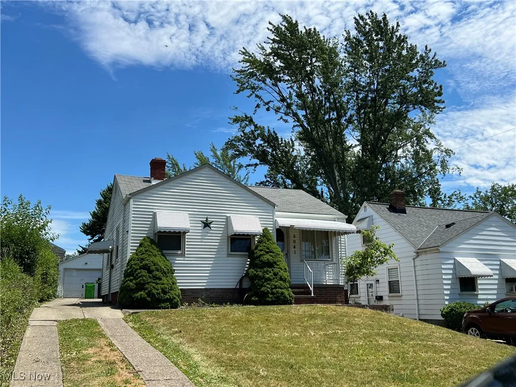 Bungalow with a front yard and a garage