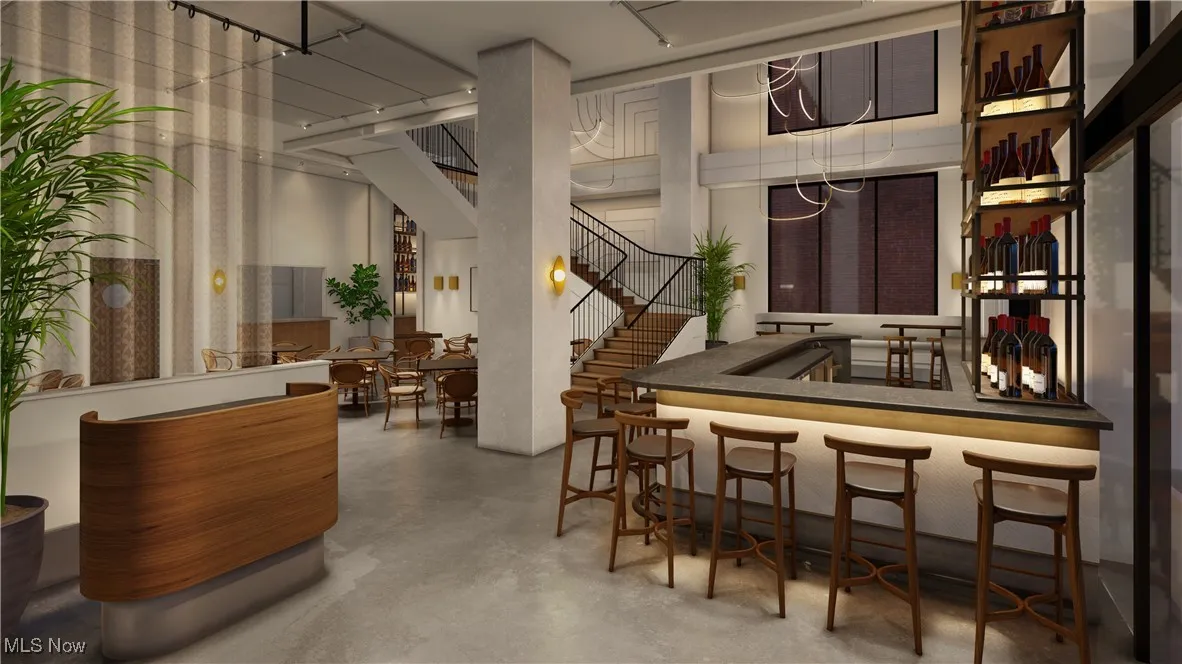 Bar with a towering ceiling and concrete flooring