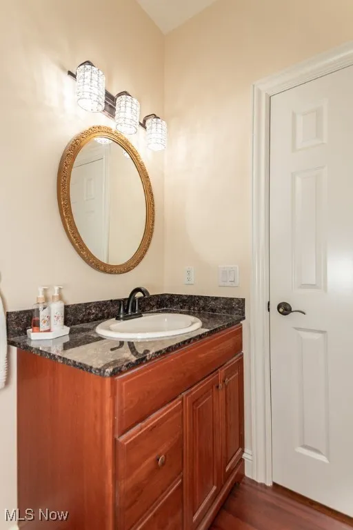 Bathroom with vanity and hardwood / wood-style floors