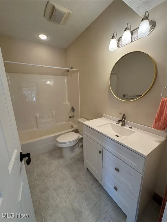 Bathroom with visible vents, a textured ceiling, toilet, and vanity