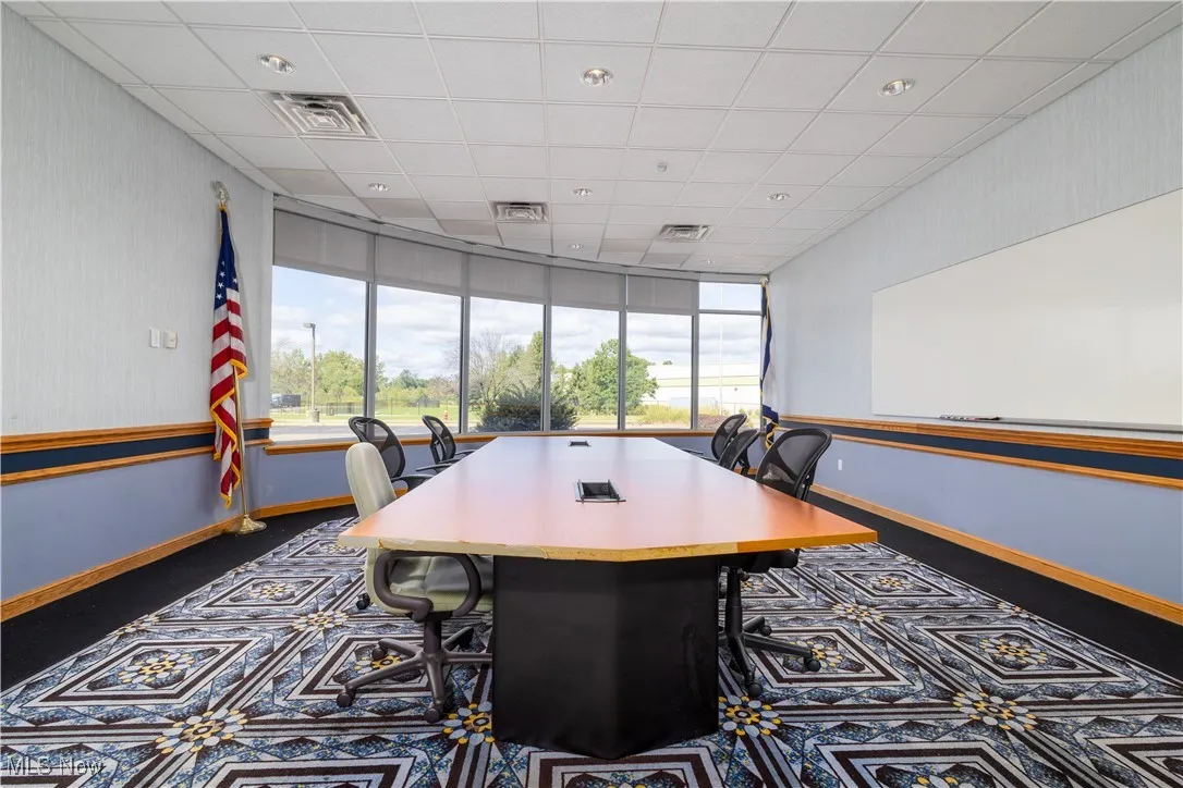 Carpeted dining room with a drop ceiling