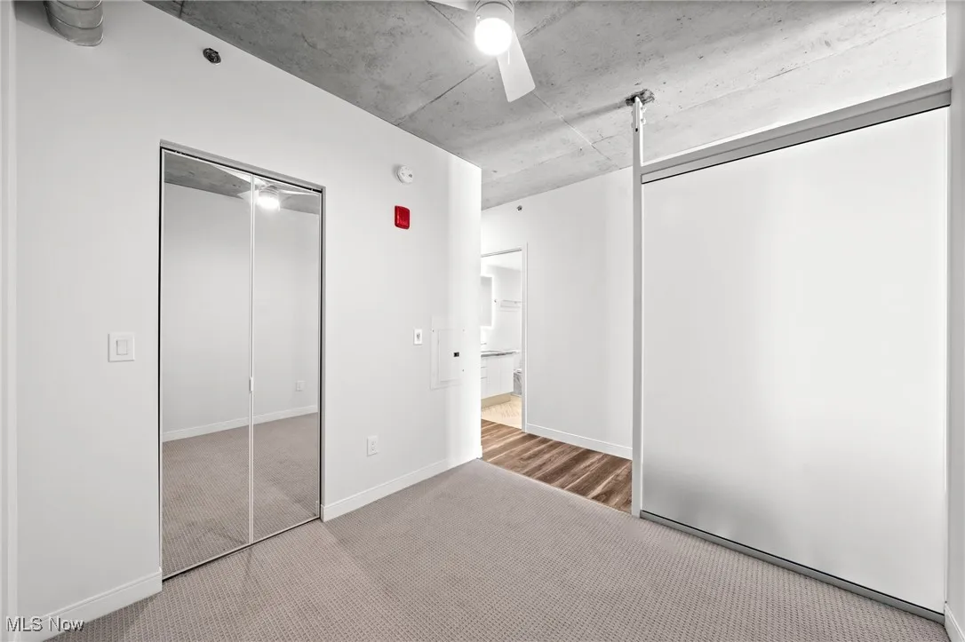 Unfurnished bedroom featuring ceiling fan and carpet flooring