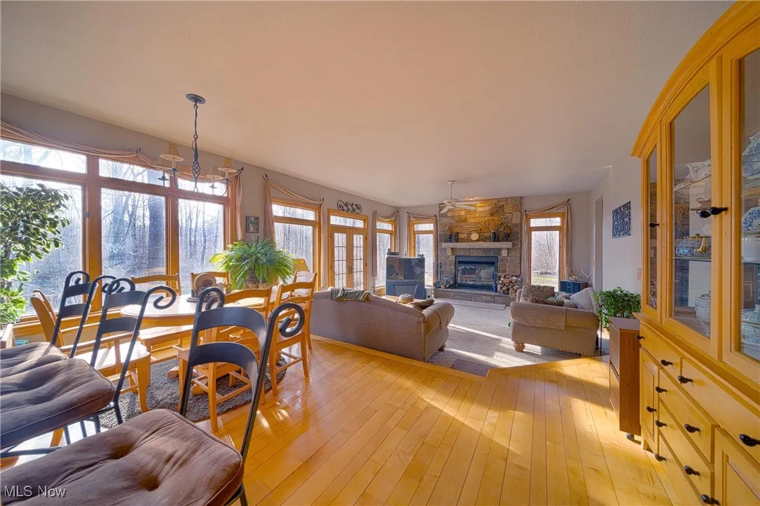 Dining area featuring a fireplace, a chandelier, and light wood-type flooring