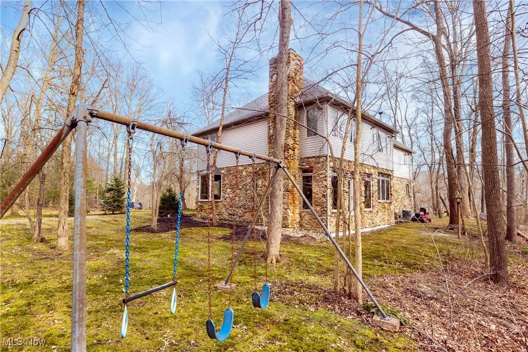 Rear view of house with a yard