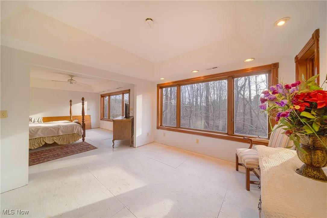 Bedroom with multiple windows and vaulted ceiling