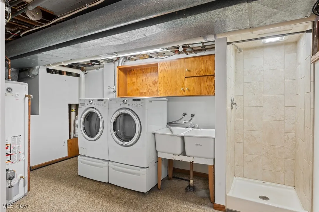 Laundry room with gas water heater and washing machine and dryer