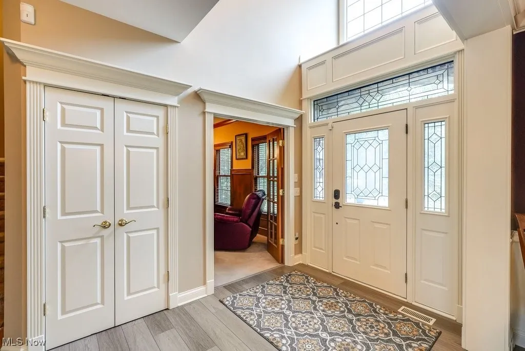 Foyer entrance with light hardwood / wood-style floors
