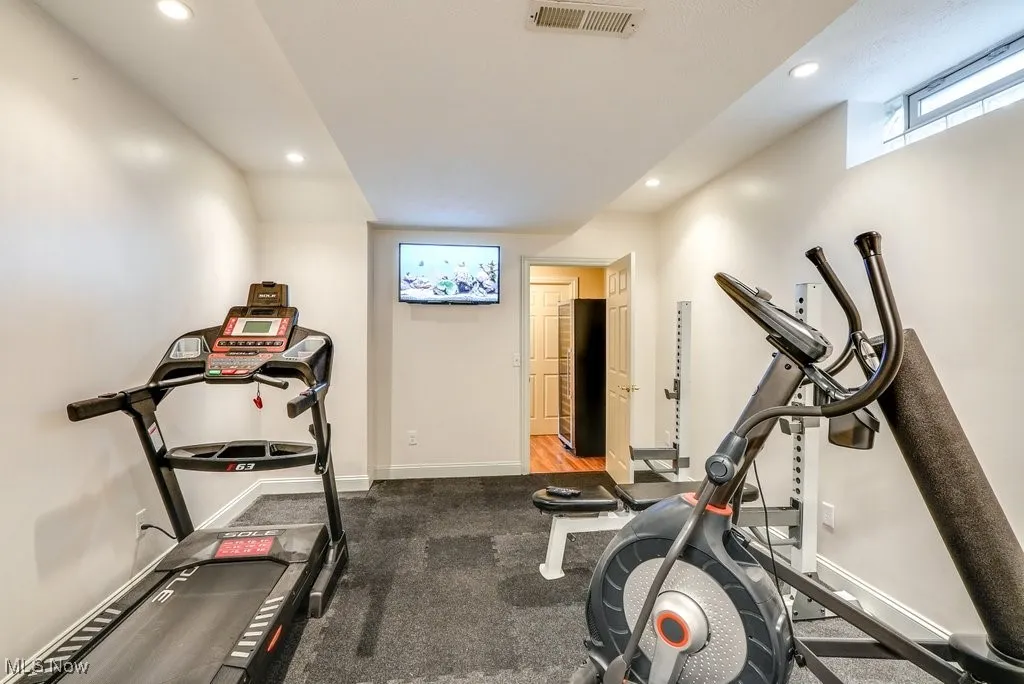 Workout area featuring dark colored carpet