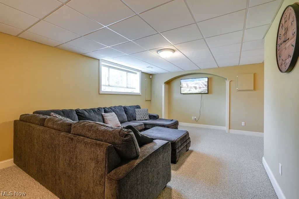 Carpeted living room with a drop ceiling