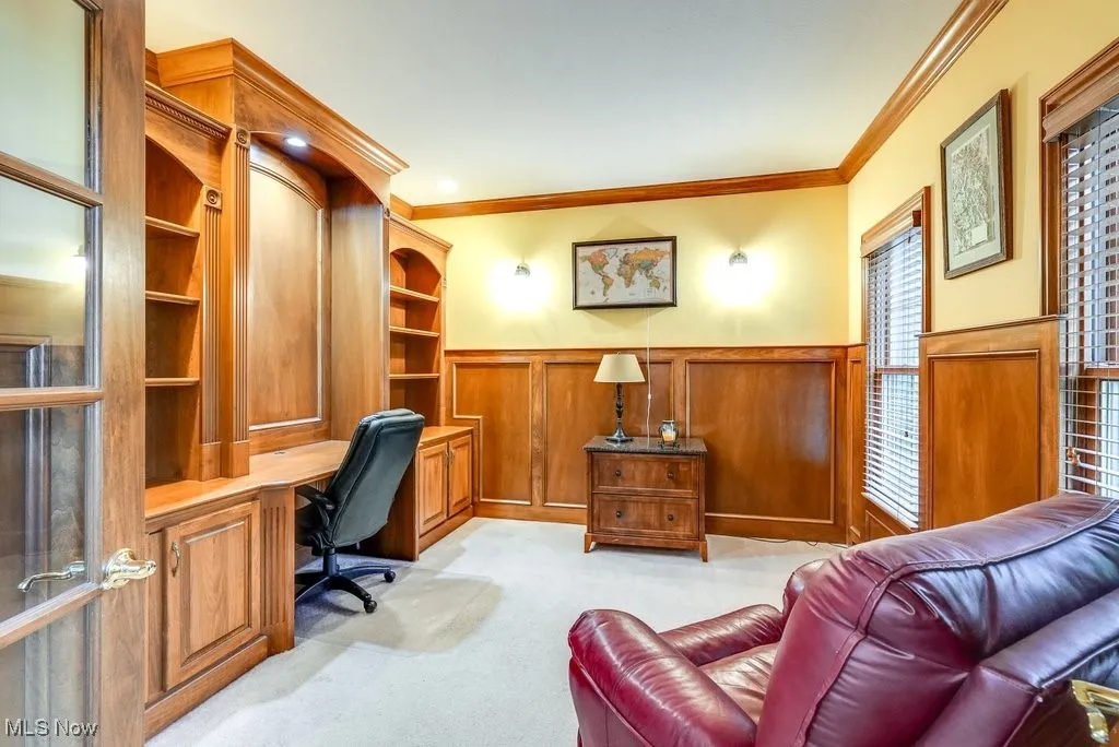 Office space featuring crown molding and light colored carpet