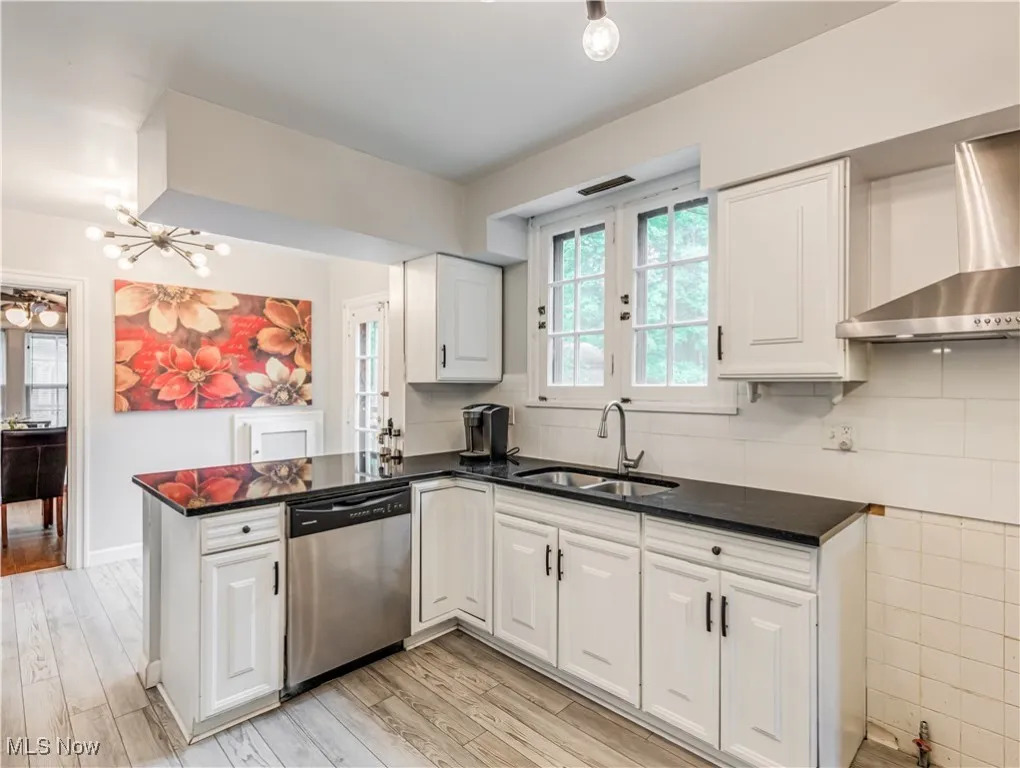 Kitchen featuring peninsula, and stainless steel dishwasher