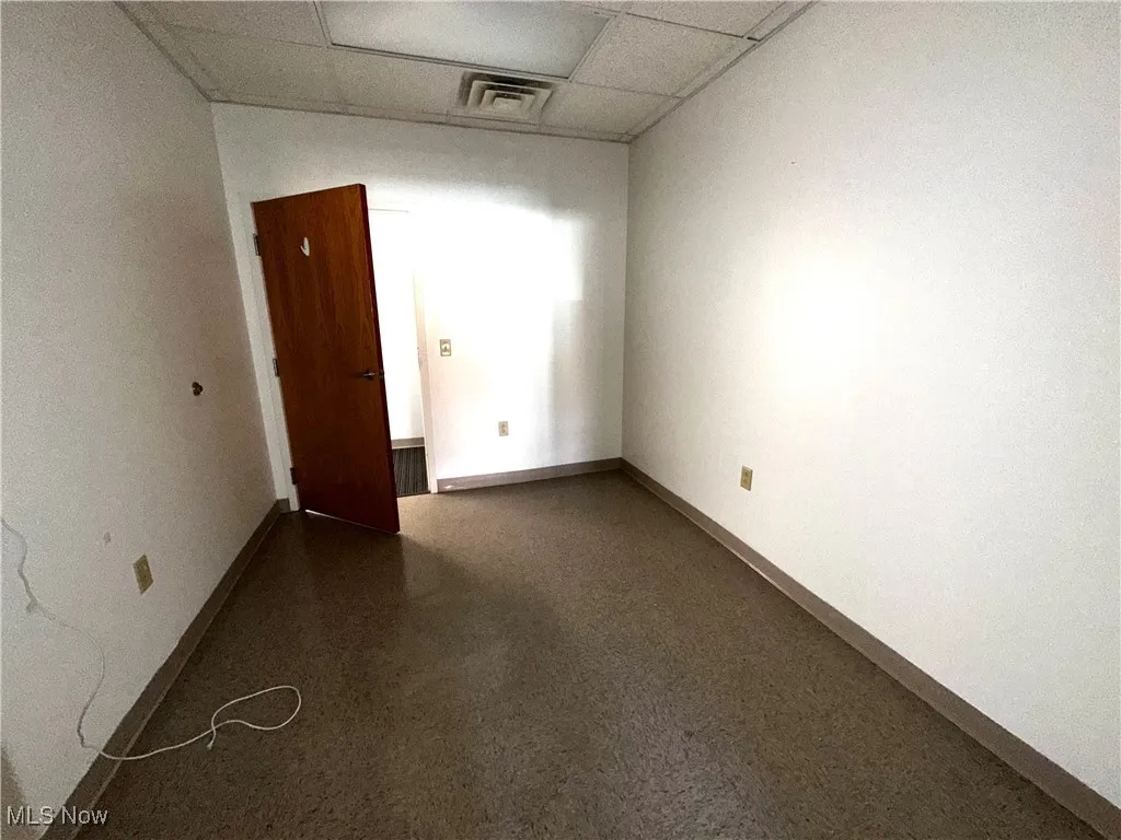 Empty room with a paneled ceiling