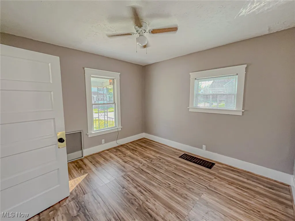 Spare room with light hardwood / wood-style flooring, a textured ceiling, and ceiling fan