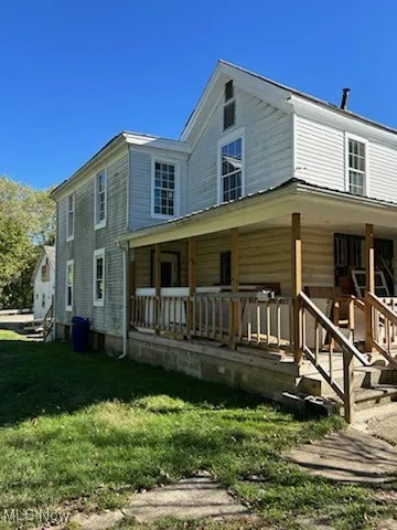 Front of house with a lawn and covered porch