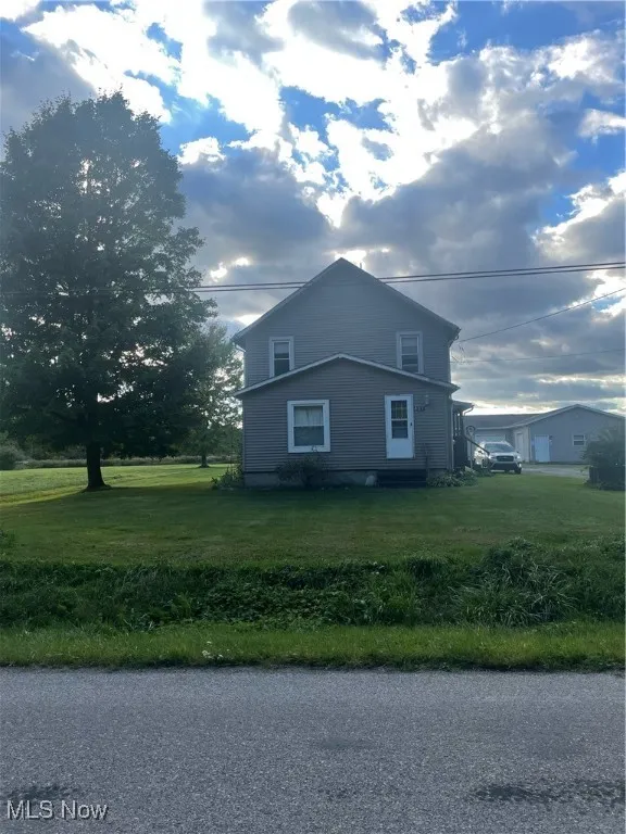 View of home's exterior with a yard