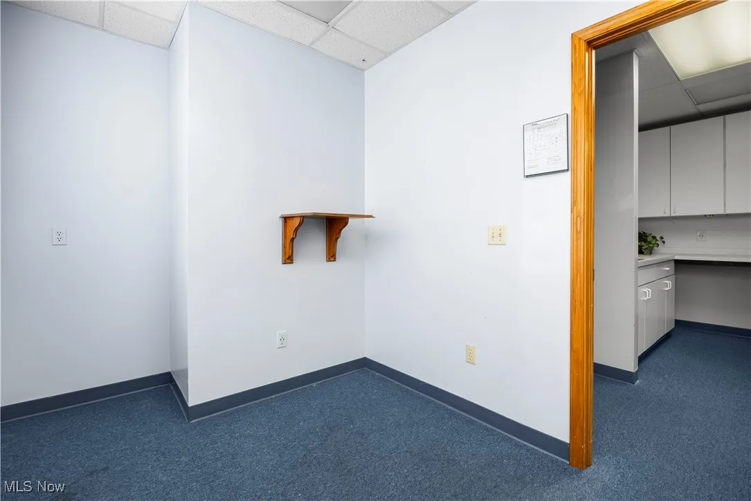 Carpeted empty room with a paneled ceiling