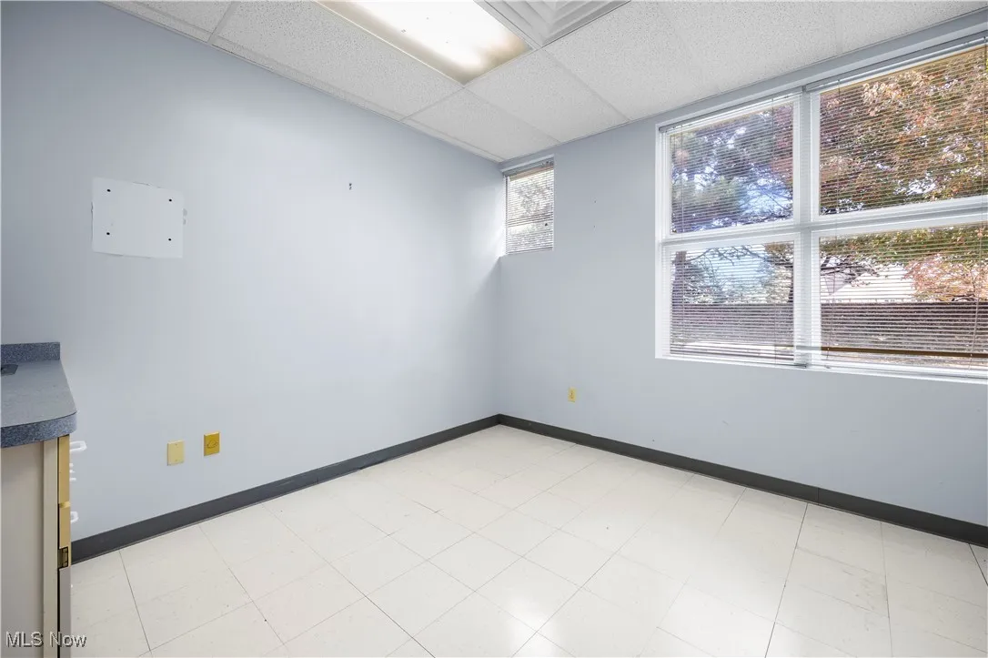 Unfurnished room featuring a drop ceiling