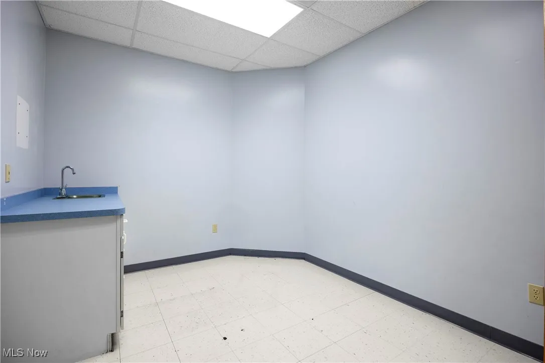 Spare room featuring a paneled ceiling and sink
