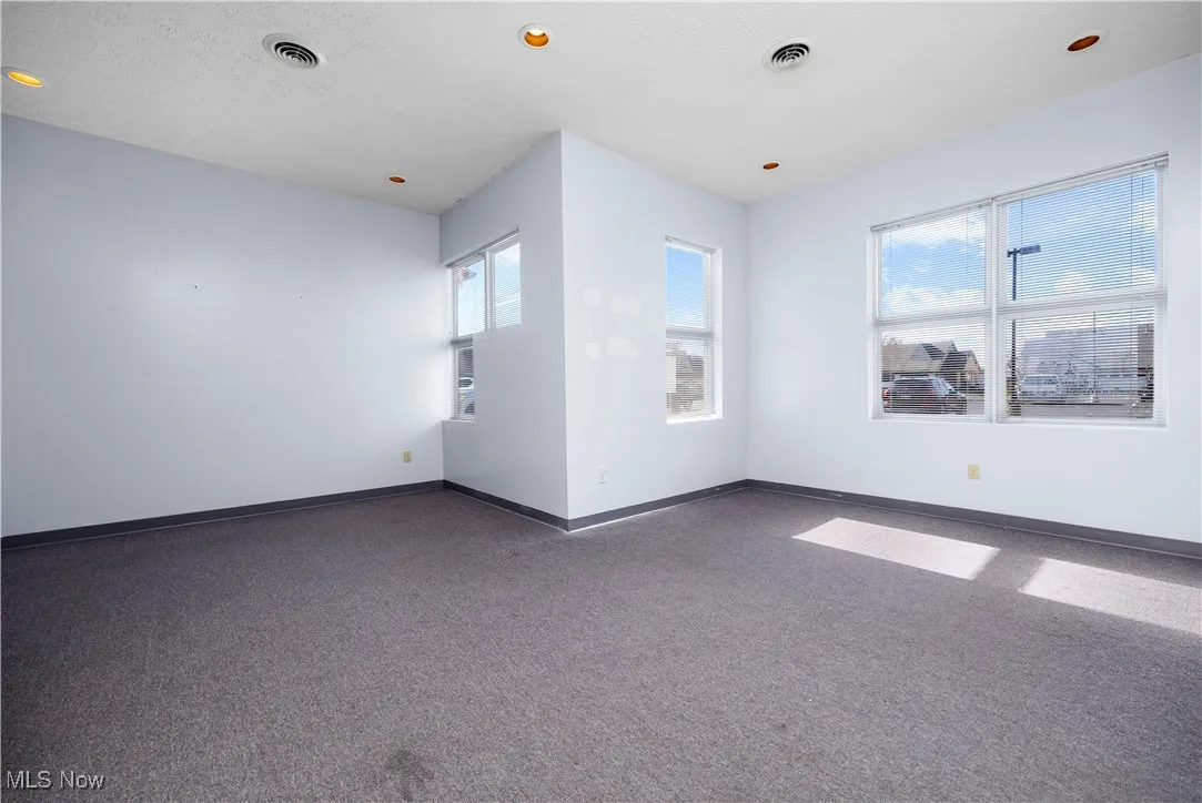 Carpeted spare room featuring a textured ceiling