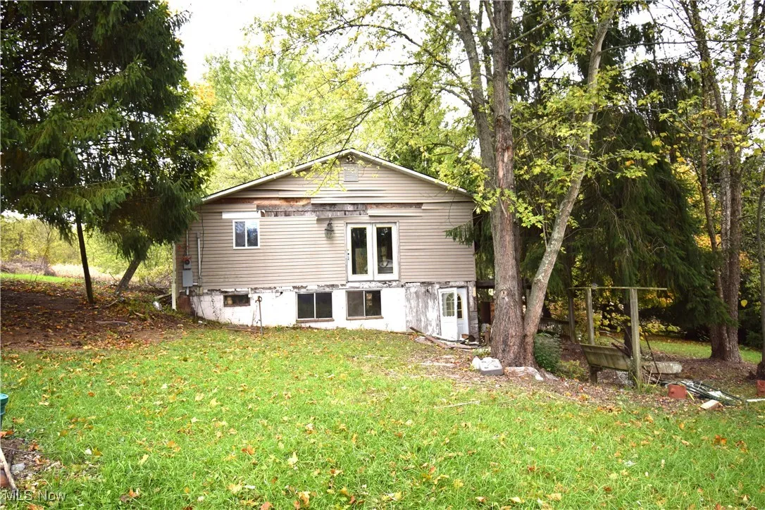 Side of house with a lawn