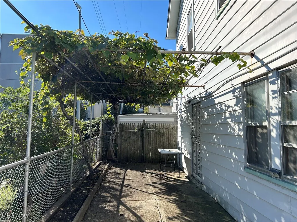Back entrance with grape arbor