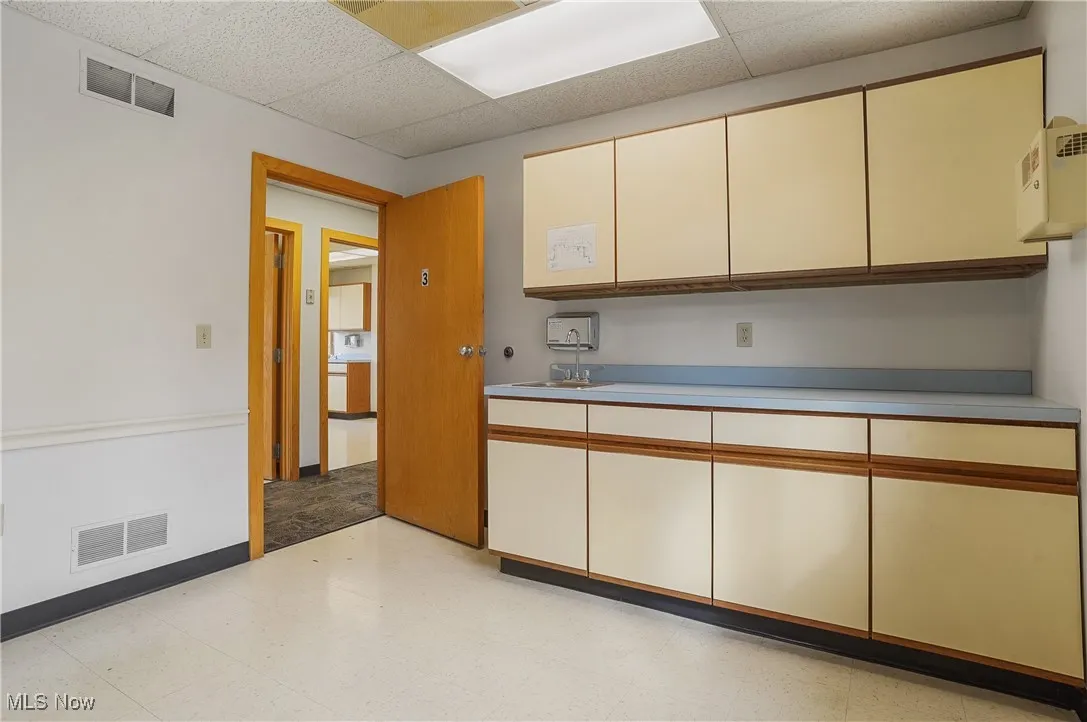 Kitchen with a paneled ceiling and sink