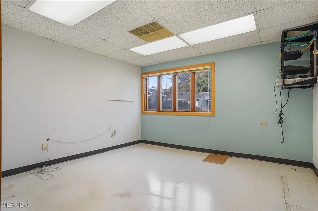 Unfurnished room featuring a drop ceiling