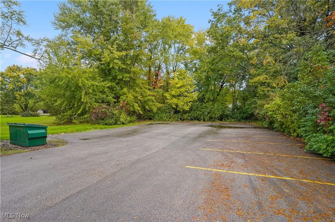 View of vehicle parking with a yard
