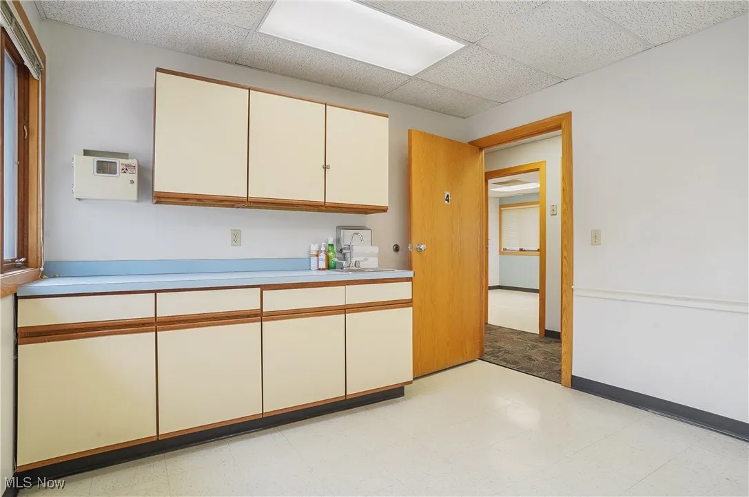 Kitchen featuring a paneled ceiling and sink