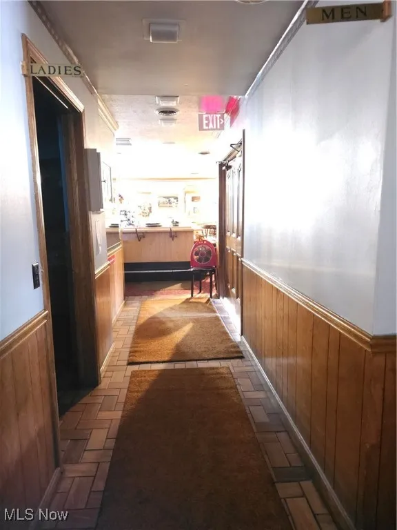 Hall featuring wood walls