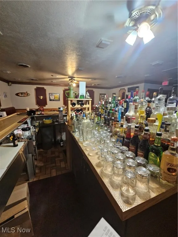 Bar with a textured ceiling and ceiling fan