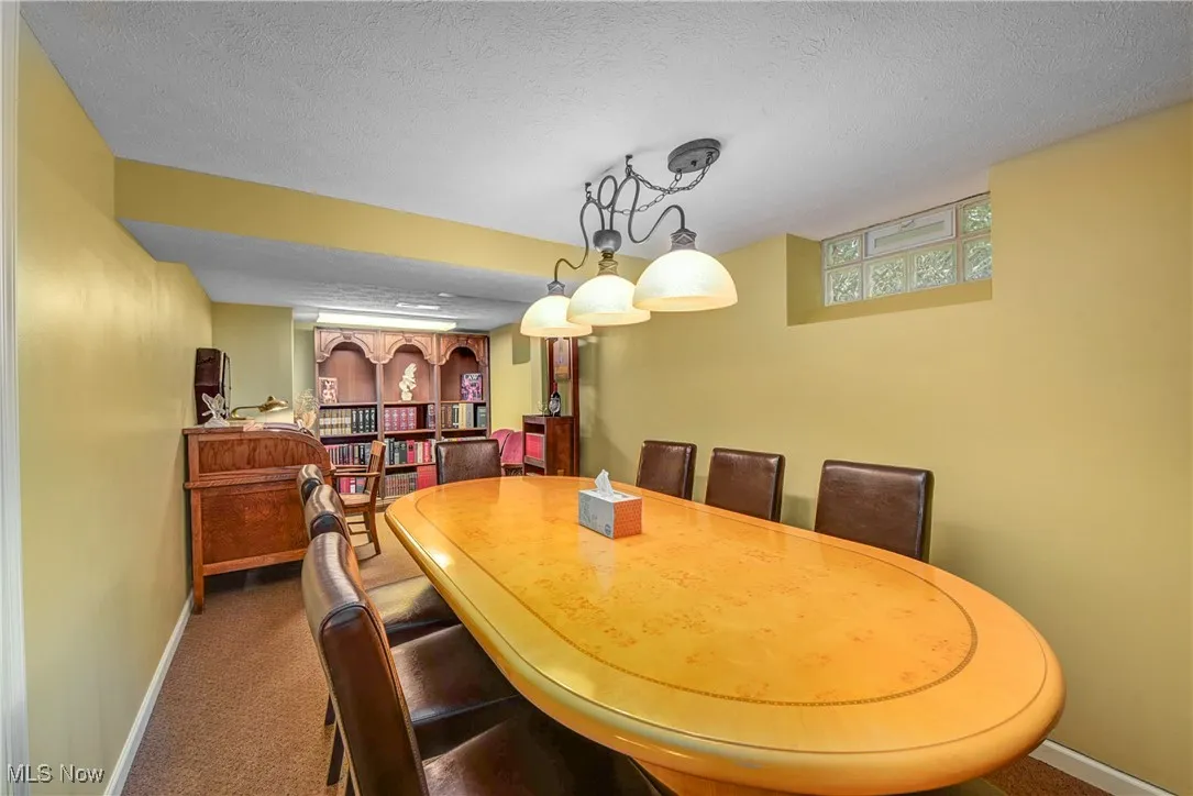 Confreence Room with dark colored carpet and a textured ceiling