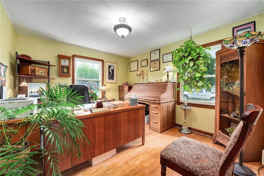 Home office with a textured ceiling and light wood-type flooring