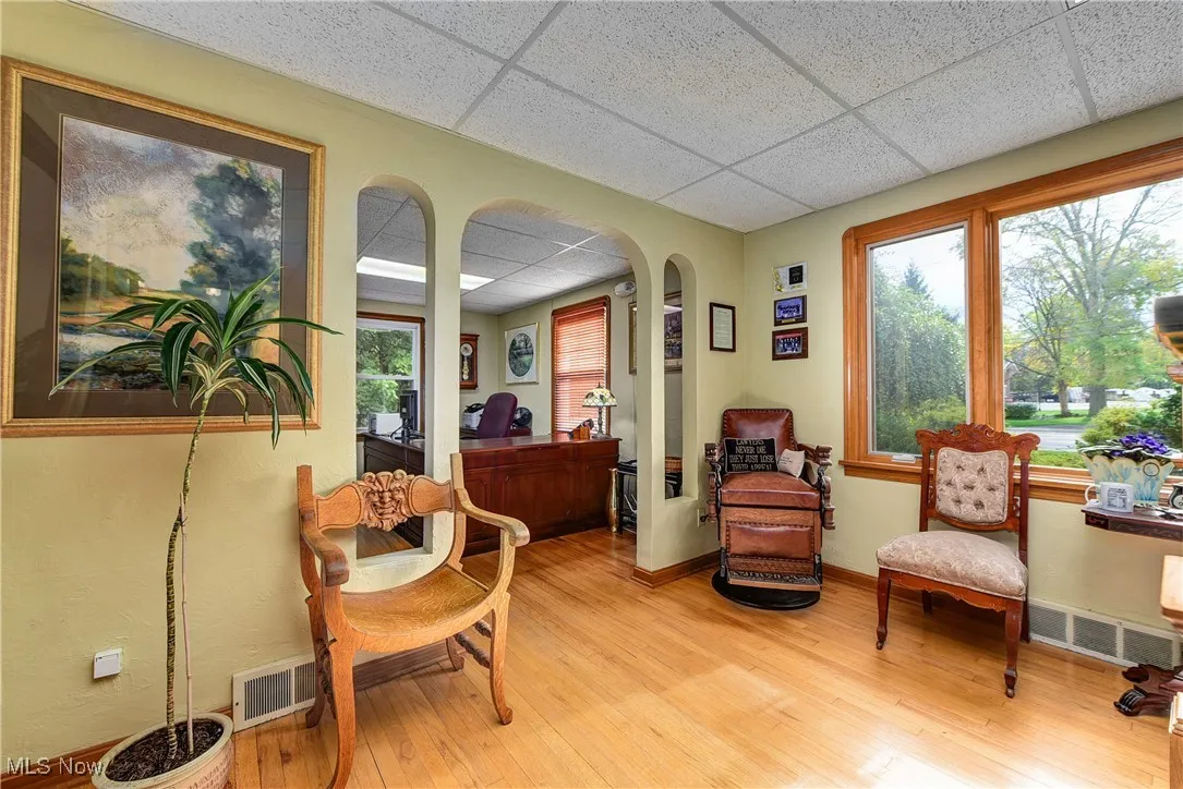 Waiting room with light hardwood / wood-style floors and a paneled ceiling