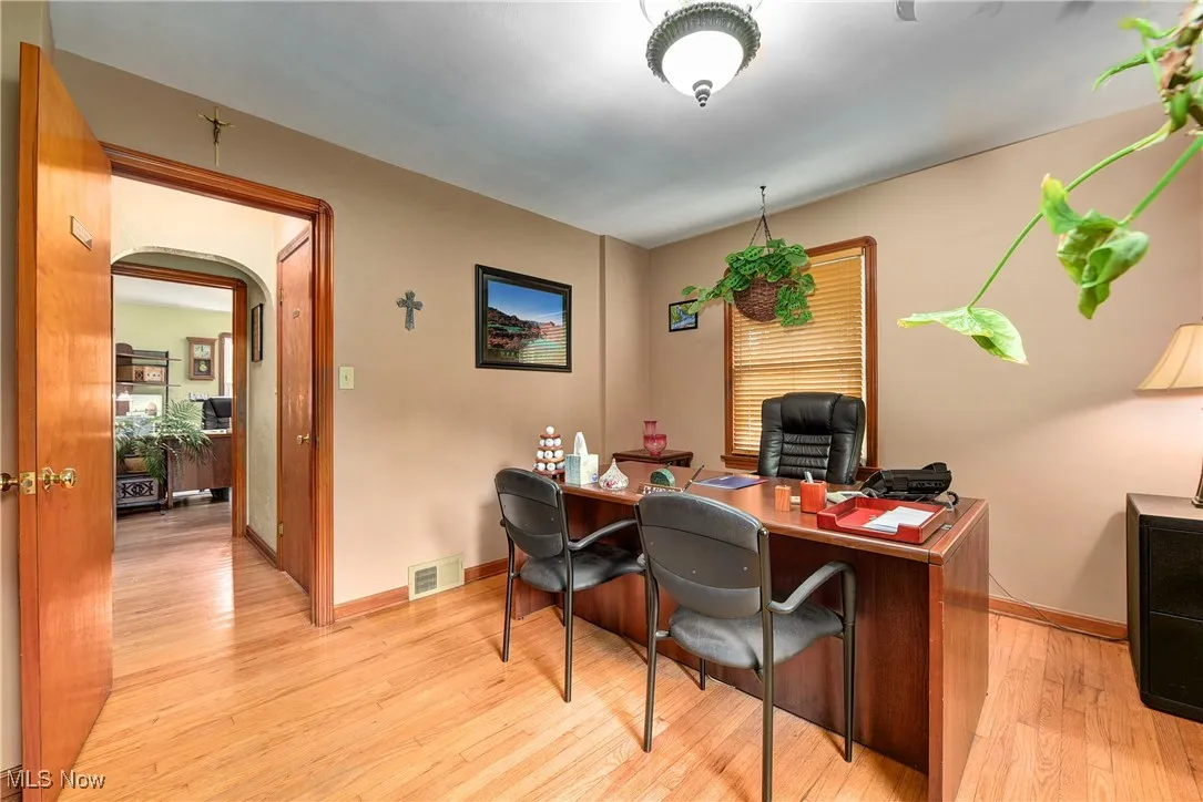 Office area with light hardwood / wood-style flooring