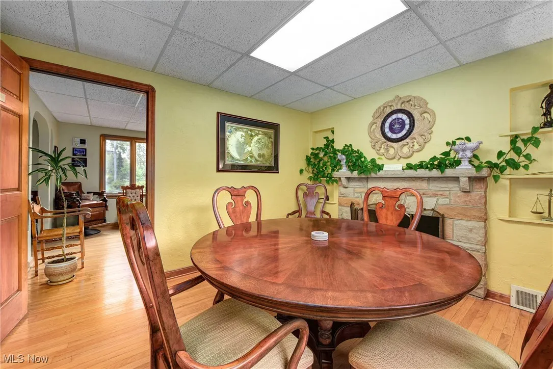 Dining space featuring light hardwood / wood-style floors and a drop ceiling
