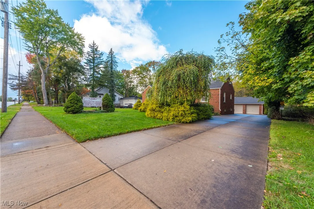 View of front facade with a front yard and a garage