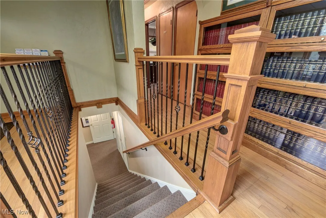 Stairway featuring hardwood / wood-style floors