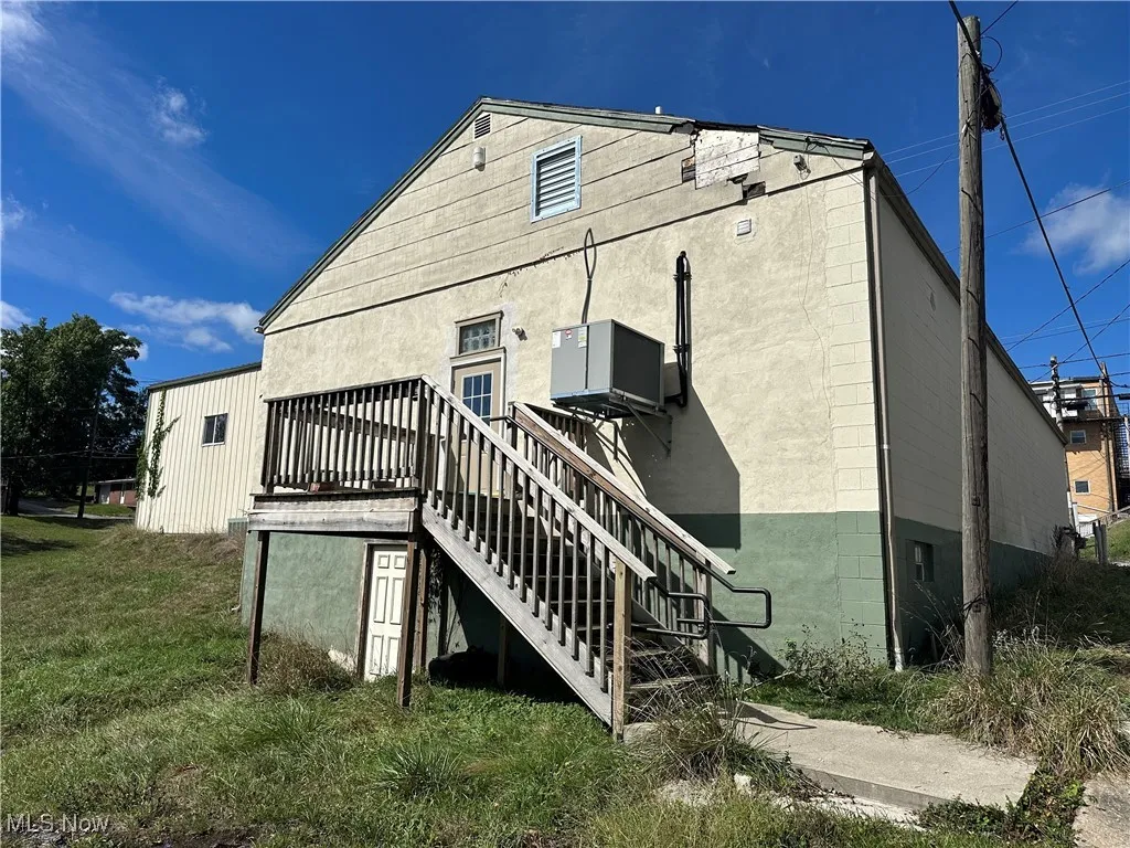 Back of property with a yard