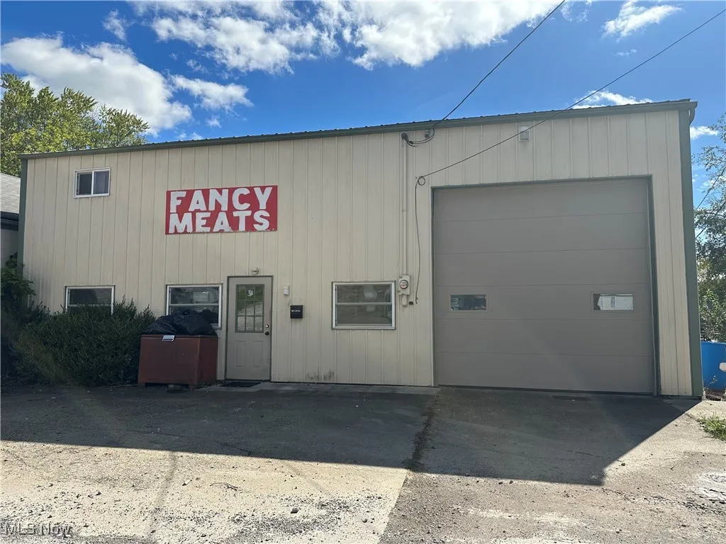 View of property featuring a garage