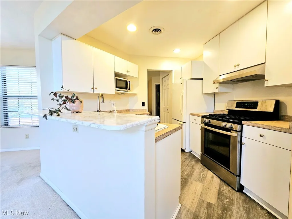 Bright kitchen with breakfast bar and pantry