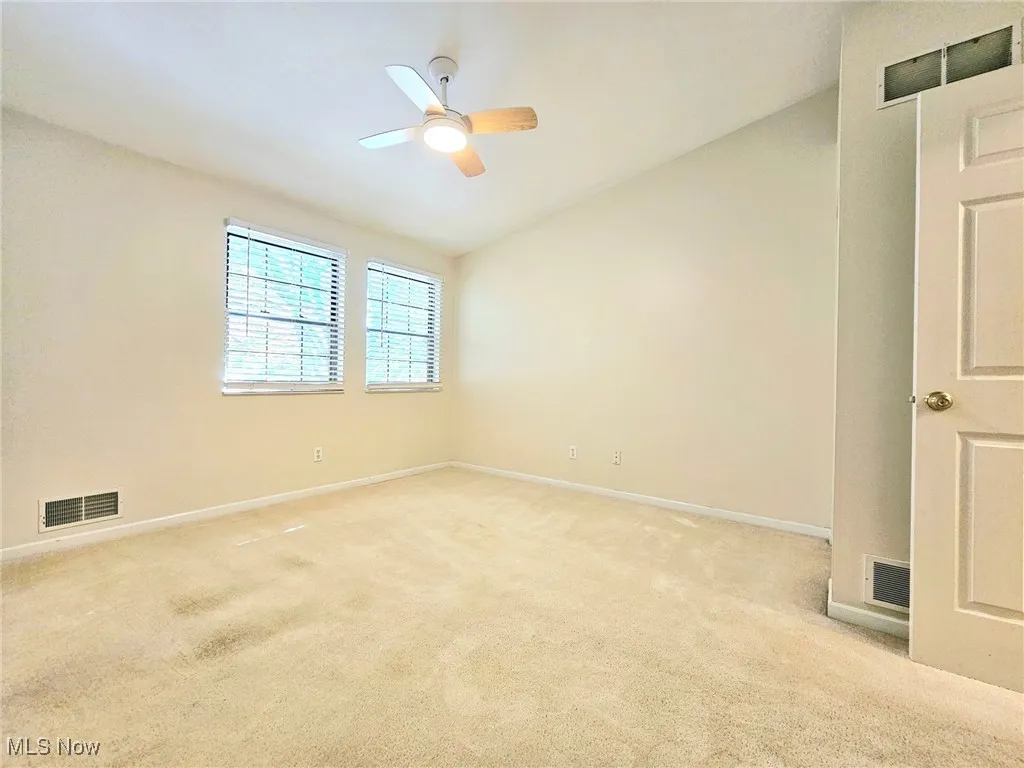 bright second bedroom with new light/ ceiling fan with remote