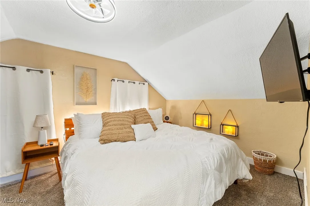 Bedroom featuring a textured ceiling and carpet flooring