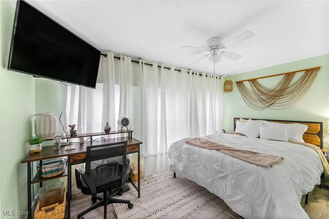 Bedroom featuring light laminate flooring and ceiling fan