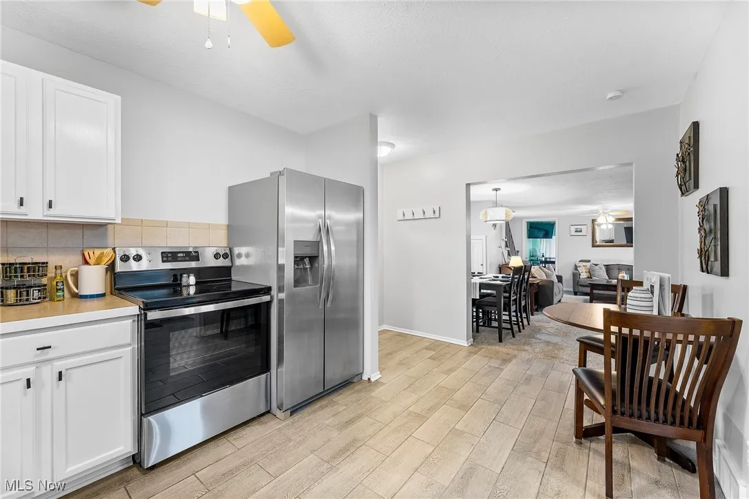 Kitchen featuring white cabinetry, stainless steel appliances