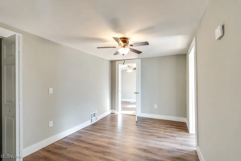 Spare room with ceiling fan and hardwood / wood-style flooring