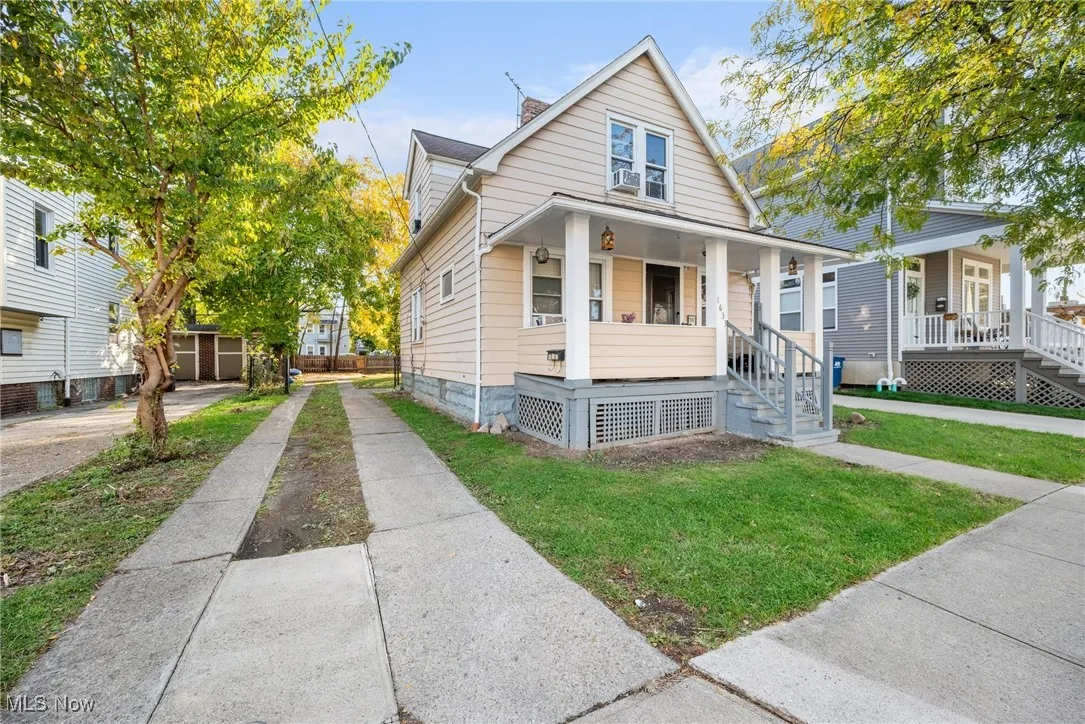 Bungalow-style house featuring covered porch and a front yard