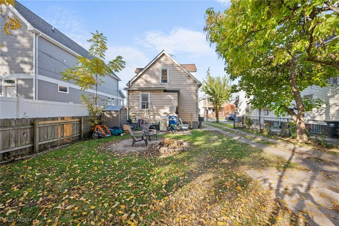 Rear view of house with a patio and a lawn