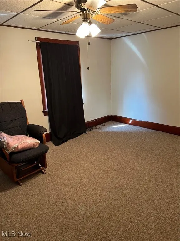 Unfurnished room with carpet floors, a paneled ceiling, and ceiling fan