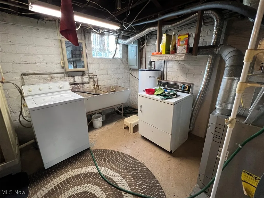 Clothes washing area with electric panel, sink, and heating unit